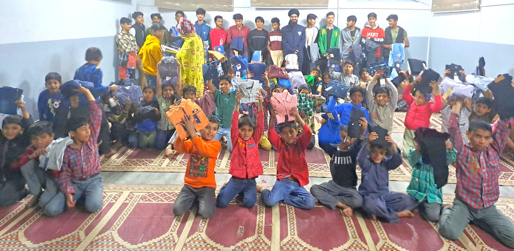 Lahore, Pakistan - Participating in Orphan Support Program & Mobile Food Rescue Program by Serving Hot Meals with Blessed Birthday Cakes & Distributing Brand New Clothes & Goodie Bags to 75+ Beloved Orphans & Less Privileged Children