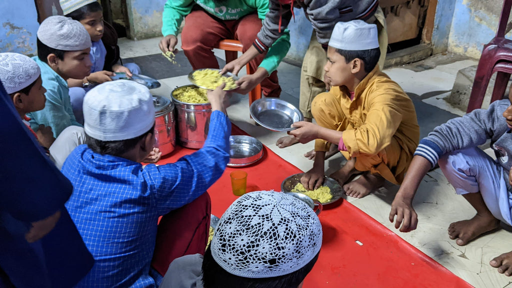 Hyderabad, India - Participating in Mobile Food Rescue Program by Serving Hot Meals to Children at Local Community's Madrasa/School